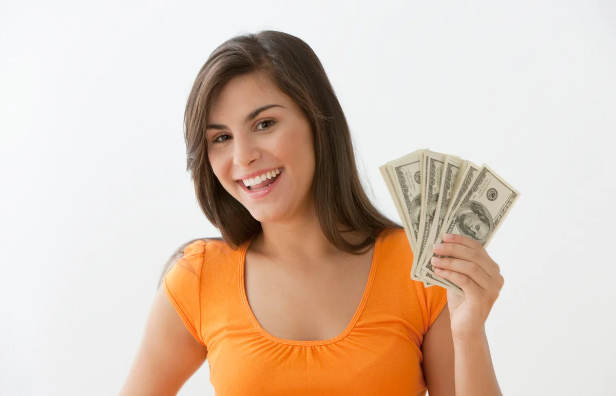 teenage girl holding cash