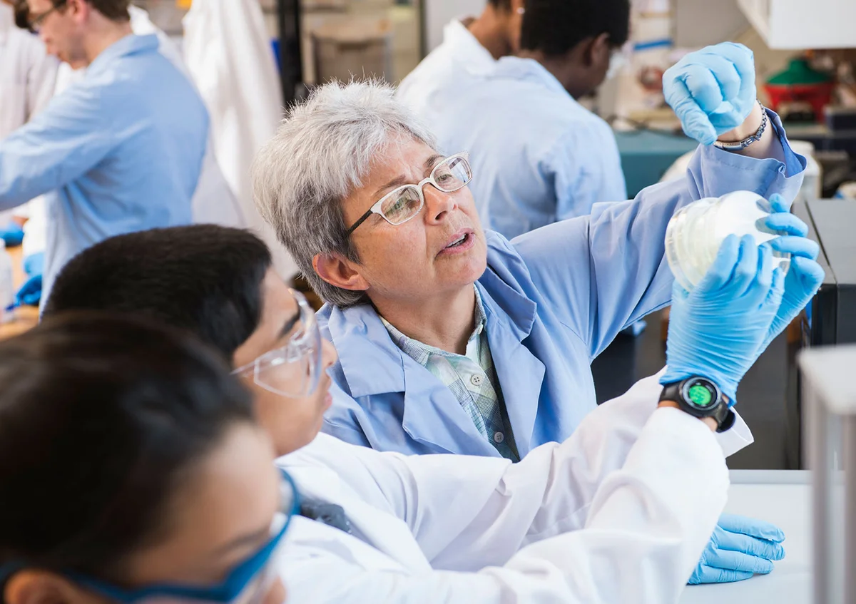 Teacher and students working in science lab
