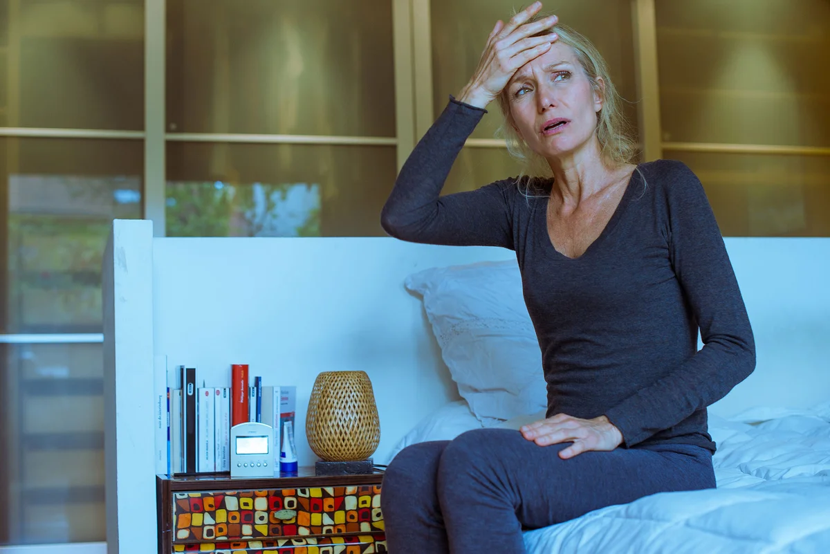 Upset woman with hand to forehead