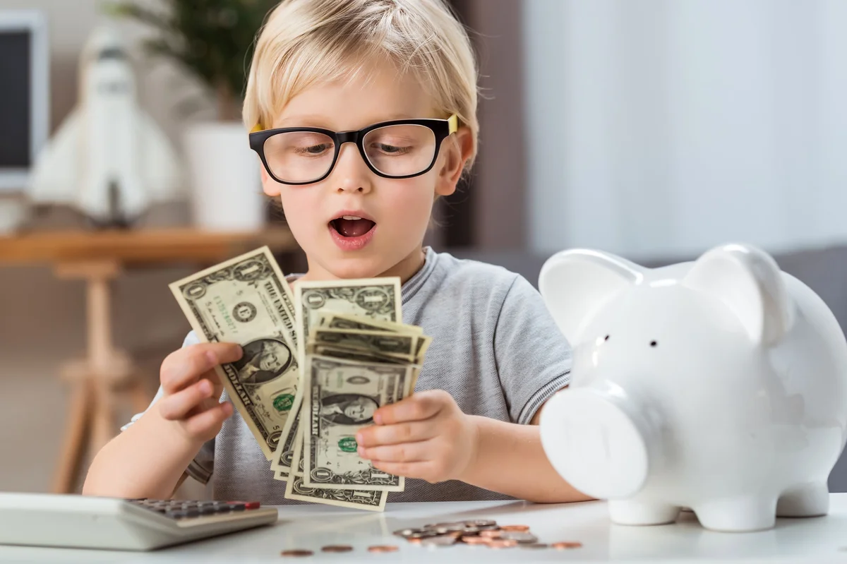 Child with glasses counting money