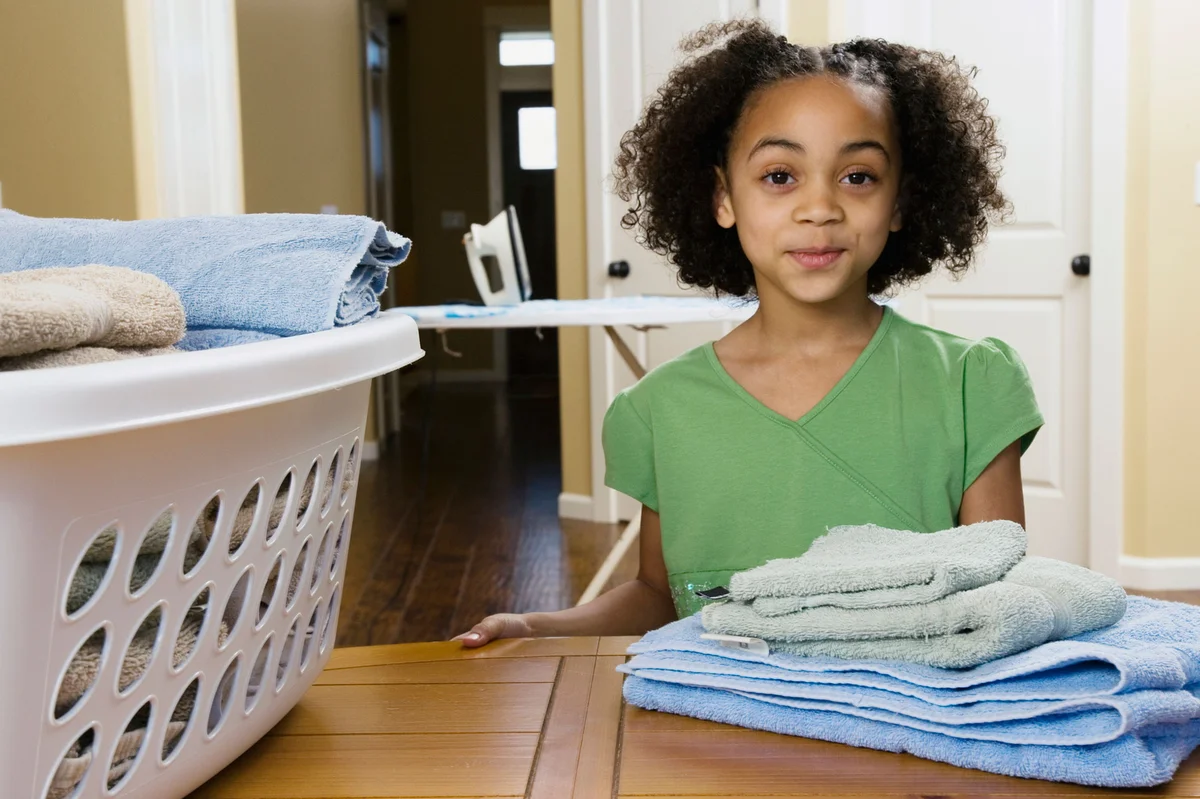 Girl with folded laundry