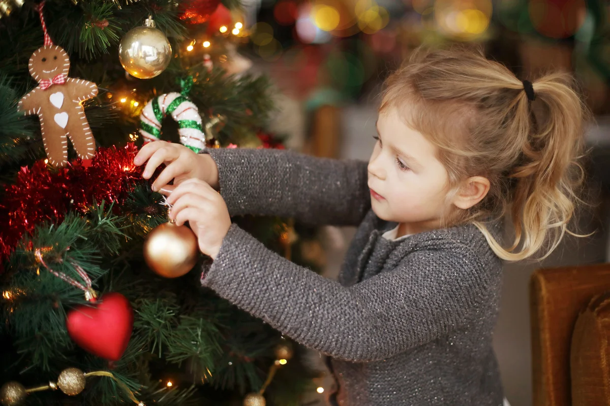 Girl decorating Christmas tree