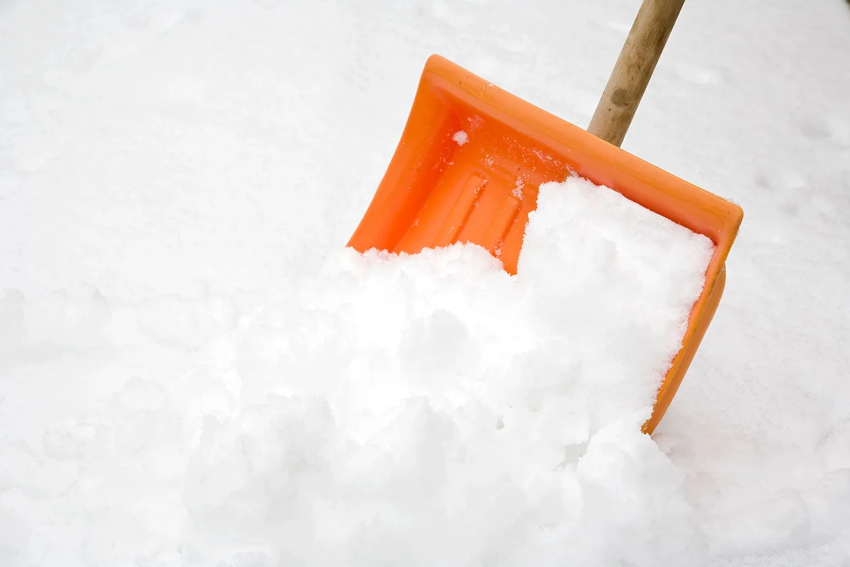 Orange shovel shoveling snow