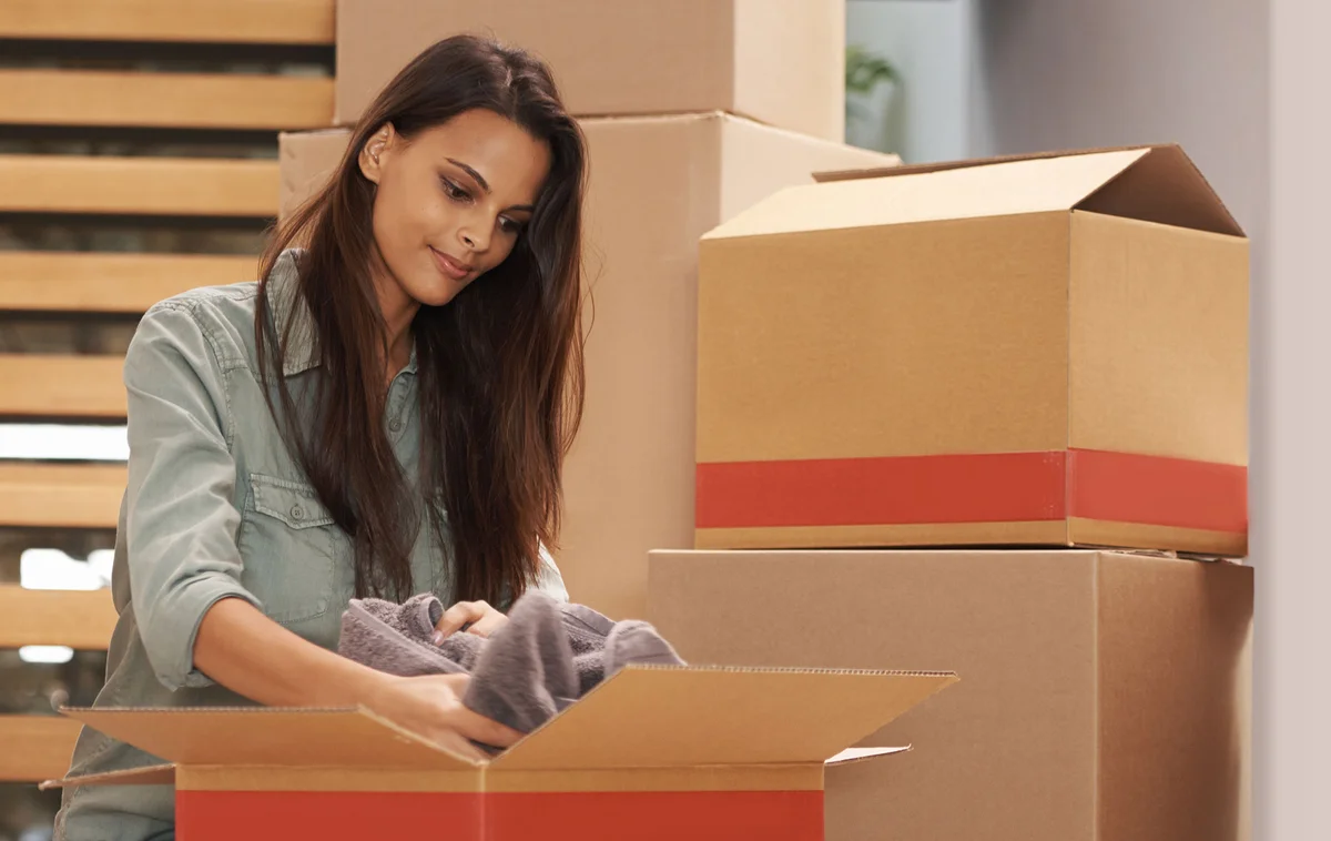 Woman packing ex's belongings in a box