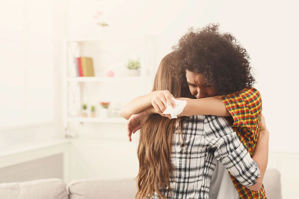 Woman comforting her sad friend