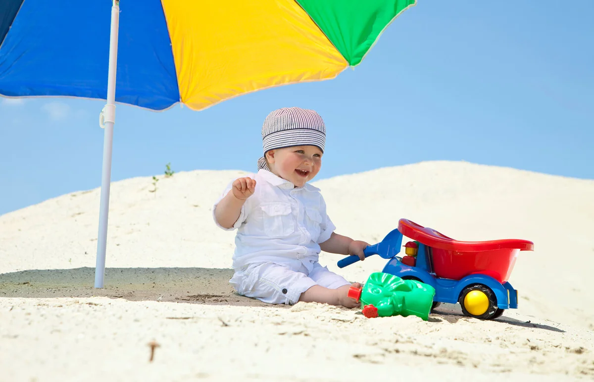 baby boy playing on beach
