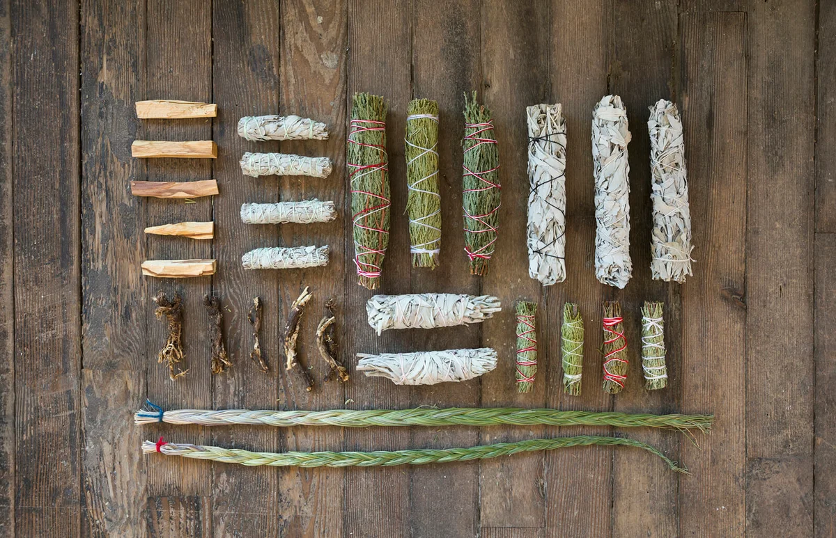 smudge sticks and patio santo on wooden floor