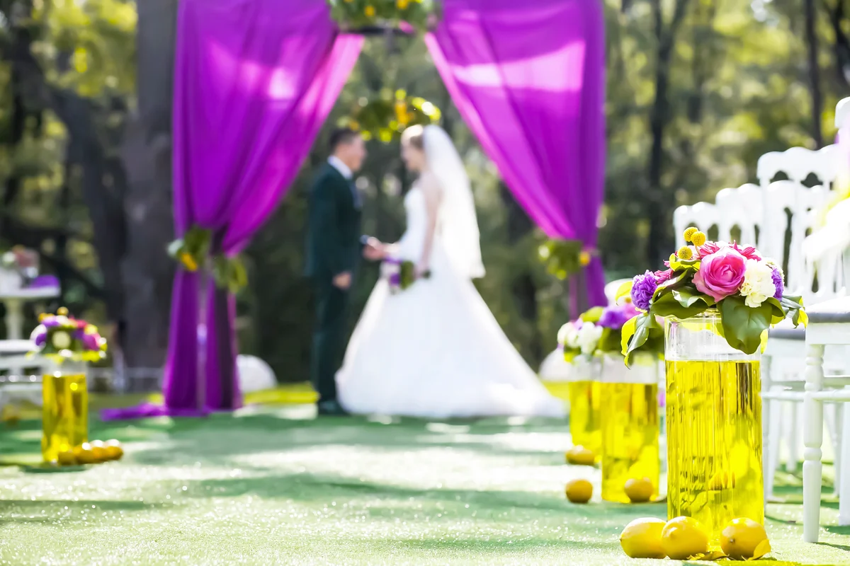 Bride and groom standing in wedding archway