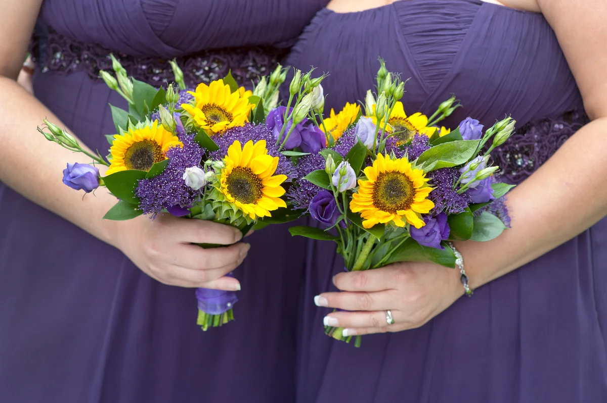 Bridesmaids in purple with sunflower bouquets