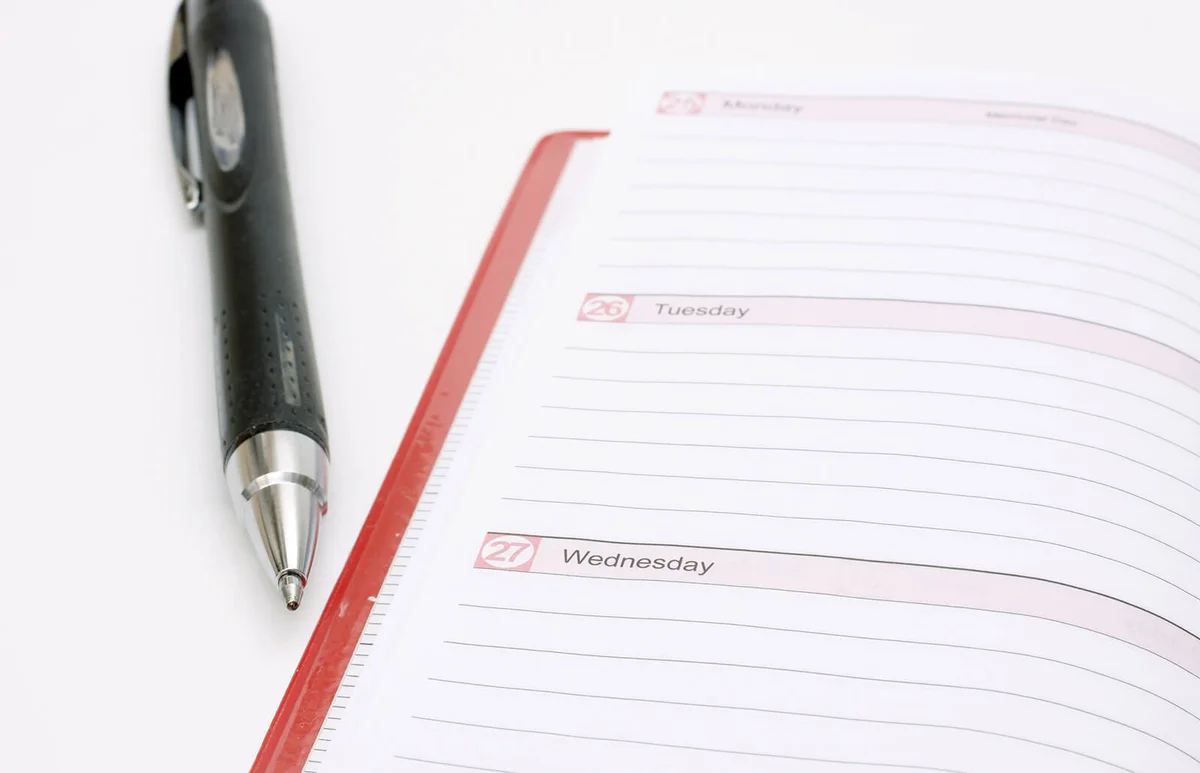 weekly planning book with pen