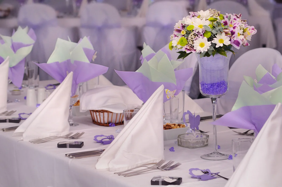 Tall violet vase with flowers centerpiece