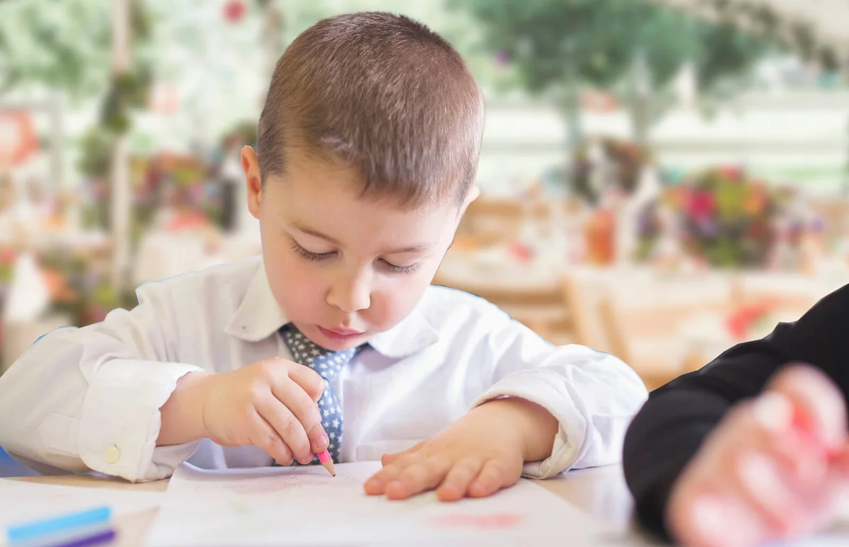 Cute boy drawing at a weeding