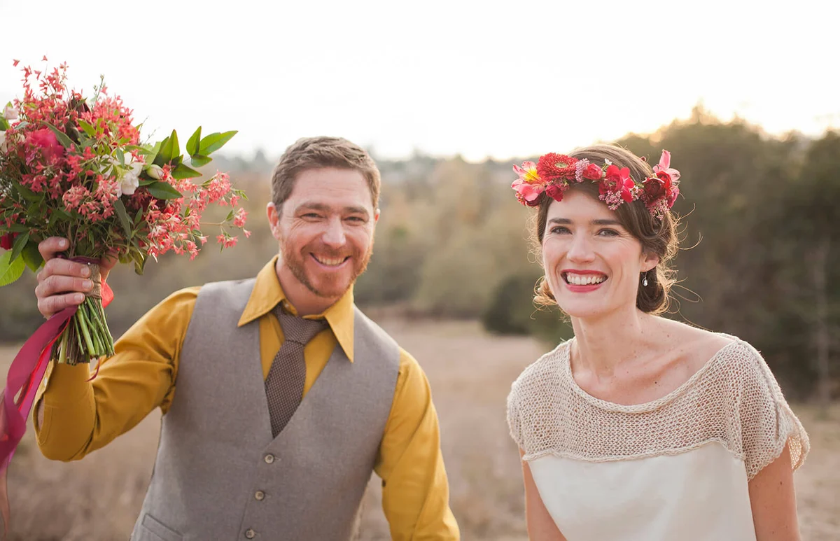 Bride and groom smiling in rural field