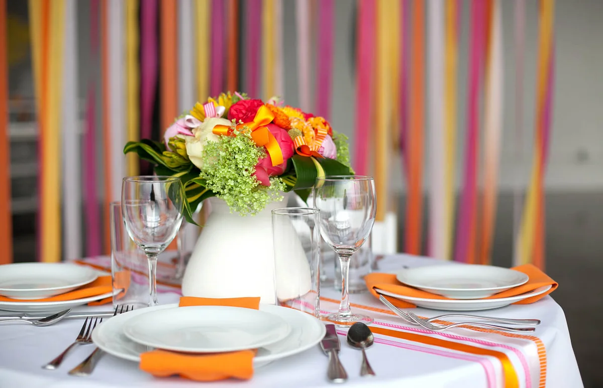 Fancy party table with flowers and ribbons