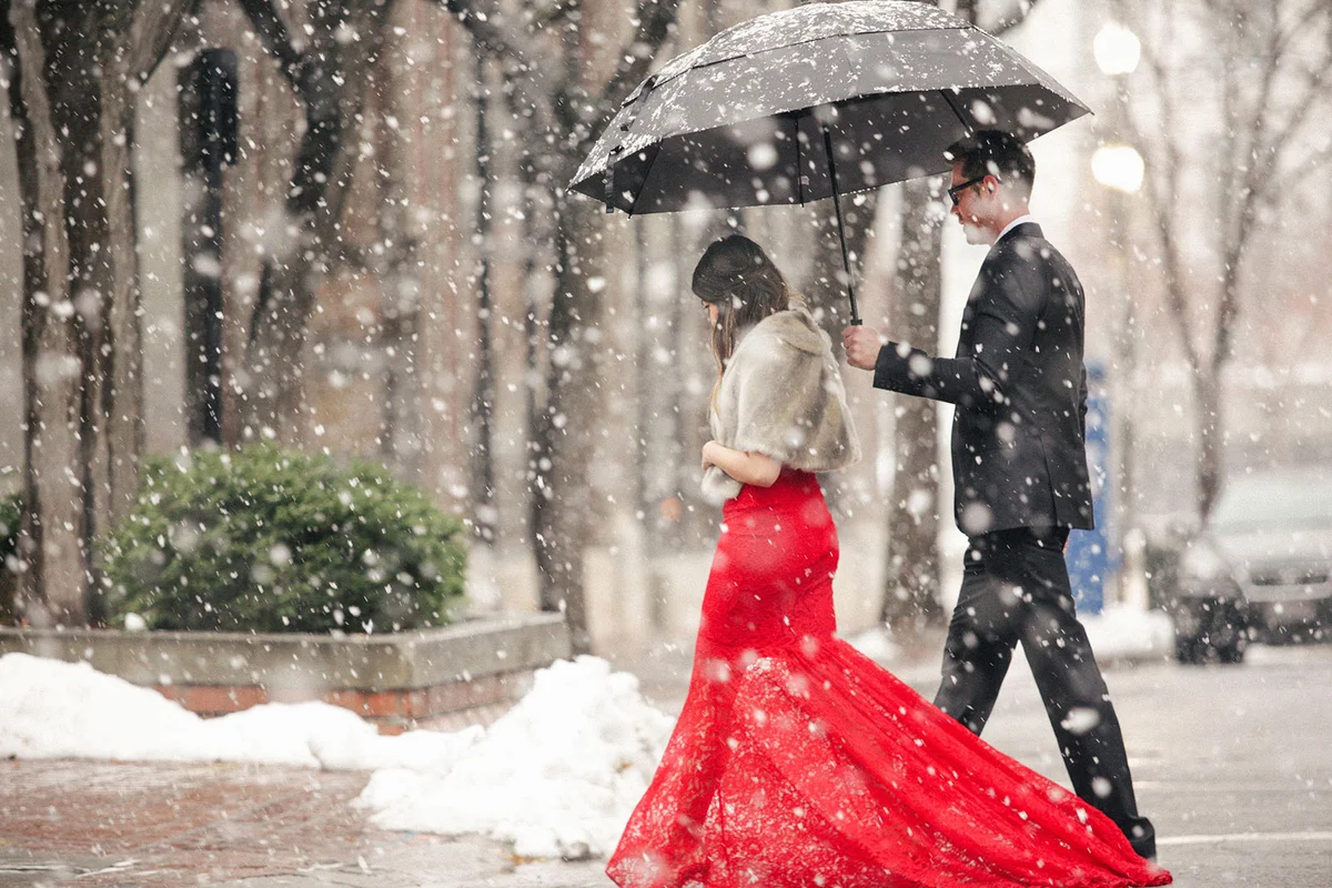 Woman in red evening gown crossing street