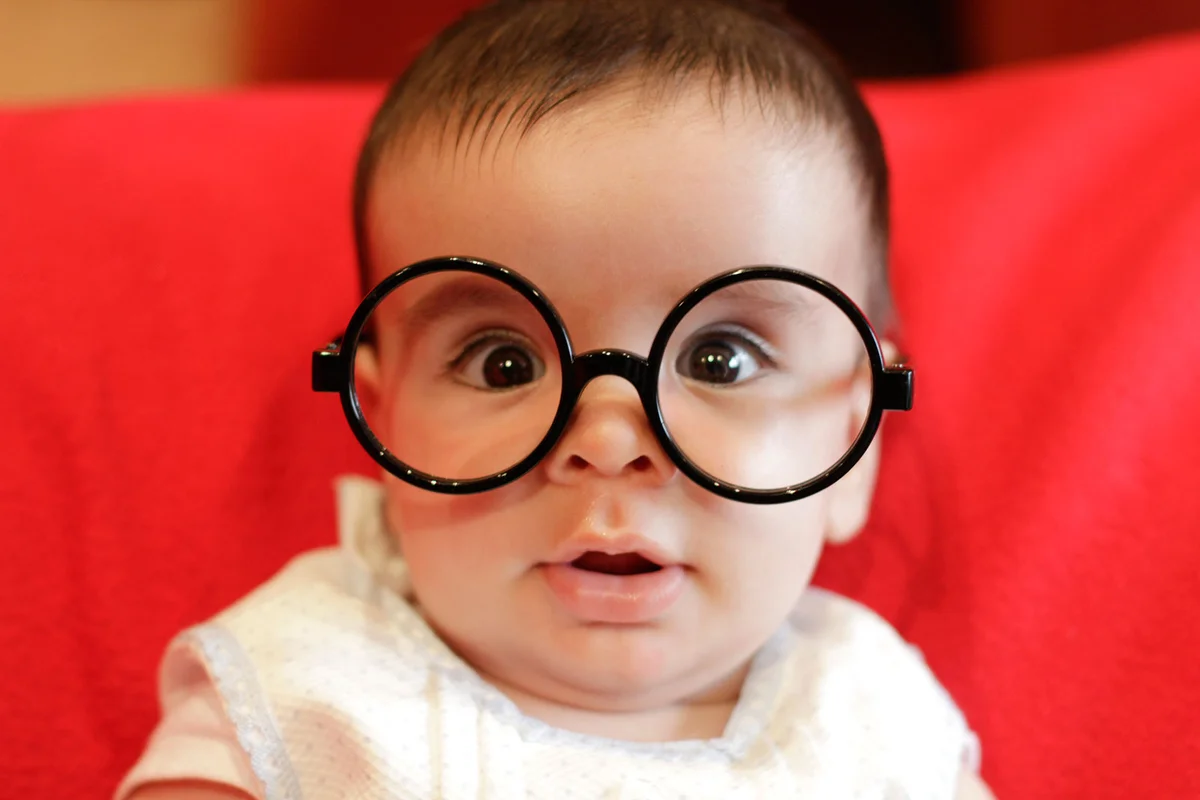 Baby wearing round black glasses