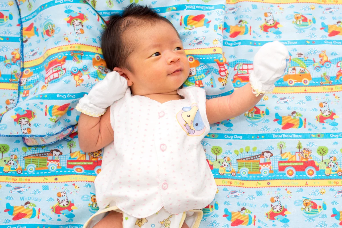 Fiesty newborn baby lying on blanket