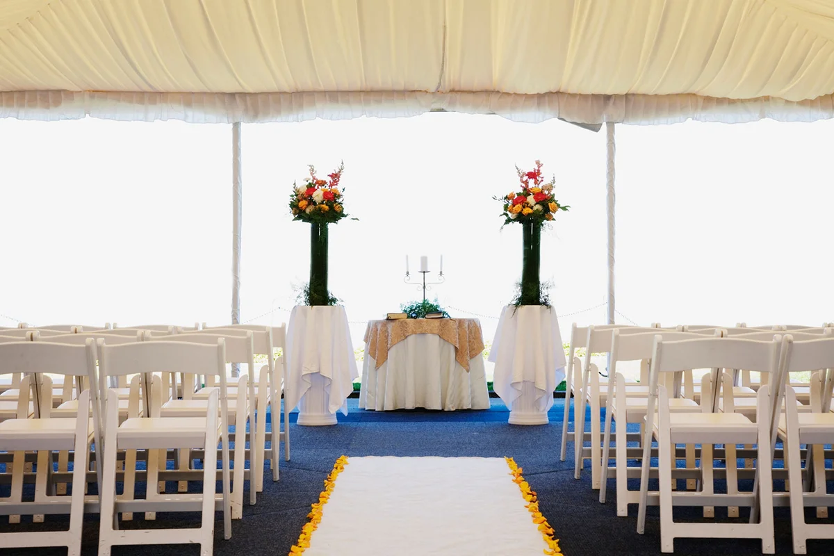 Simple inexpensive ceremony decorations in wedding tent