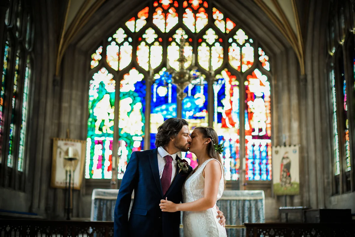 Bride and groom kissing in church