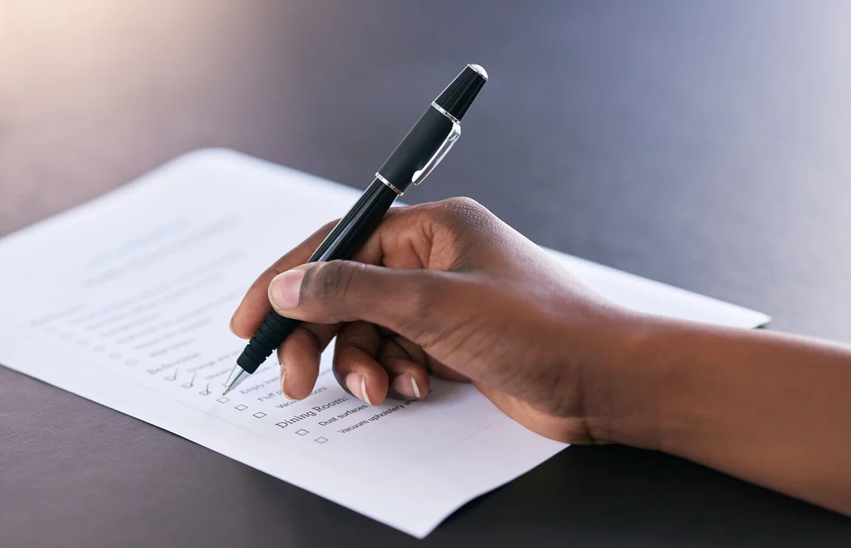 woman marking off completed tasks on a chore list