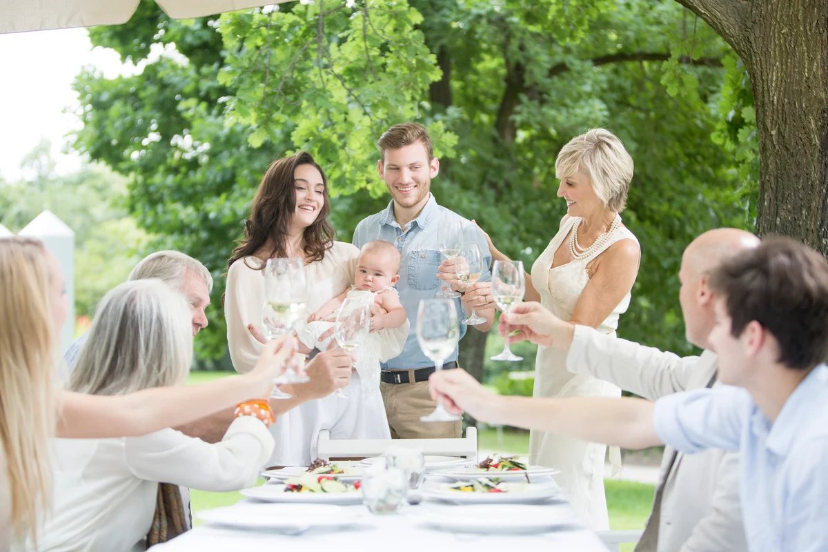 Baby being introduced to family on a garden party