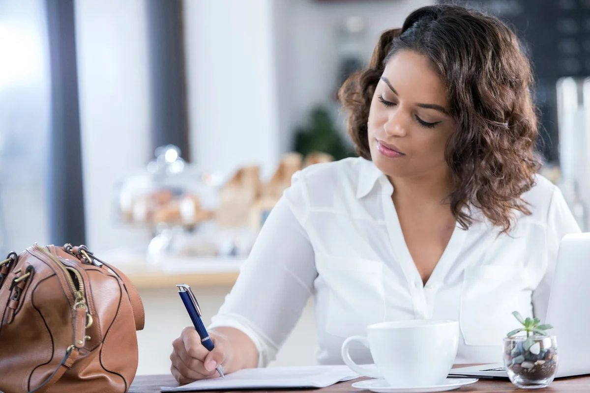 Woman jotting down ideas