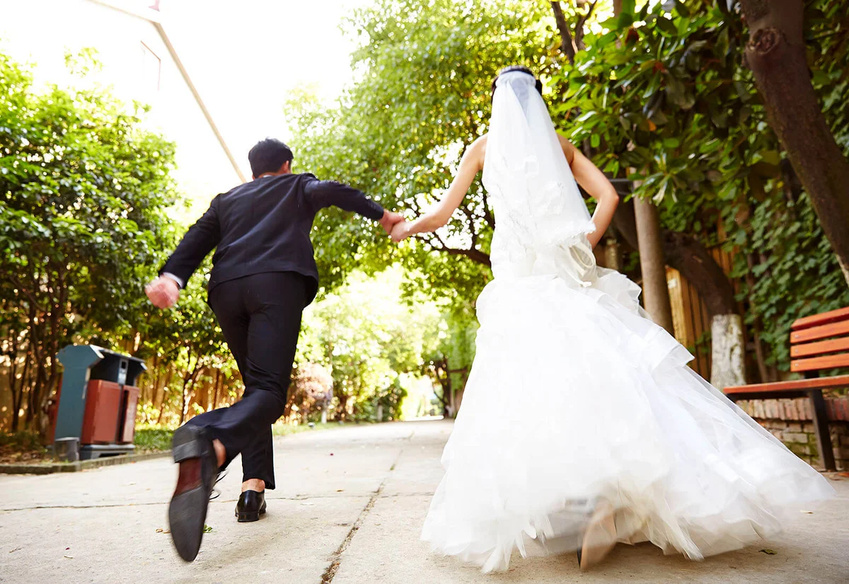 running newlywed couple