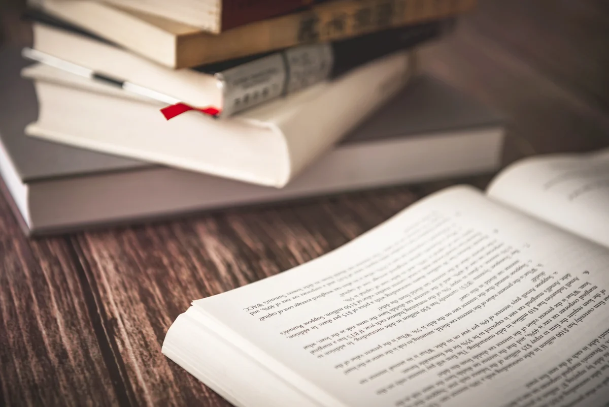 Stacked Books On Wooden Table
