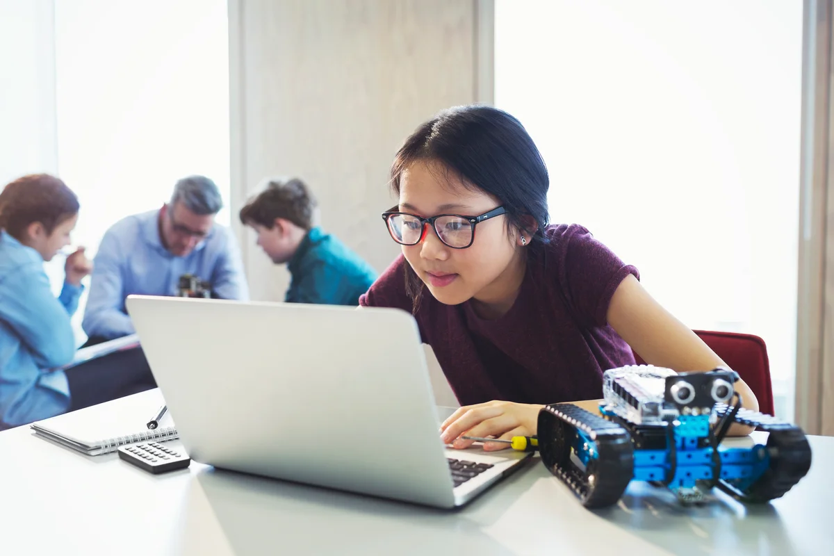 Girl with computer and robot