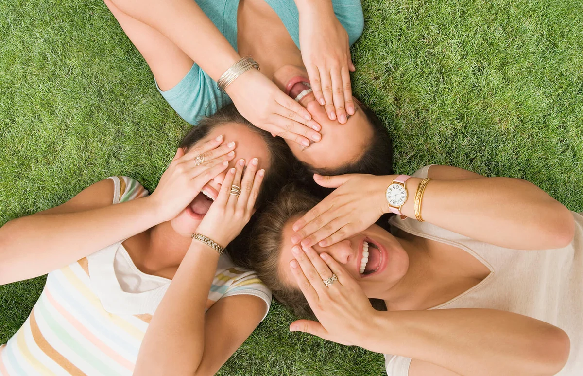 girls laying on grass