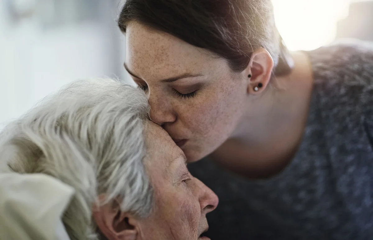 Daughter visiting her senior mother in hospital