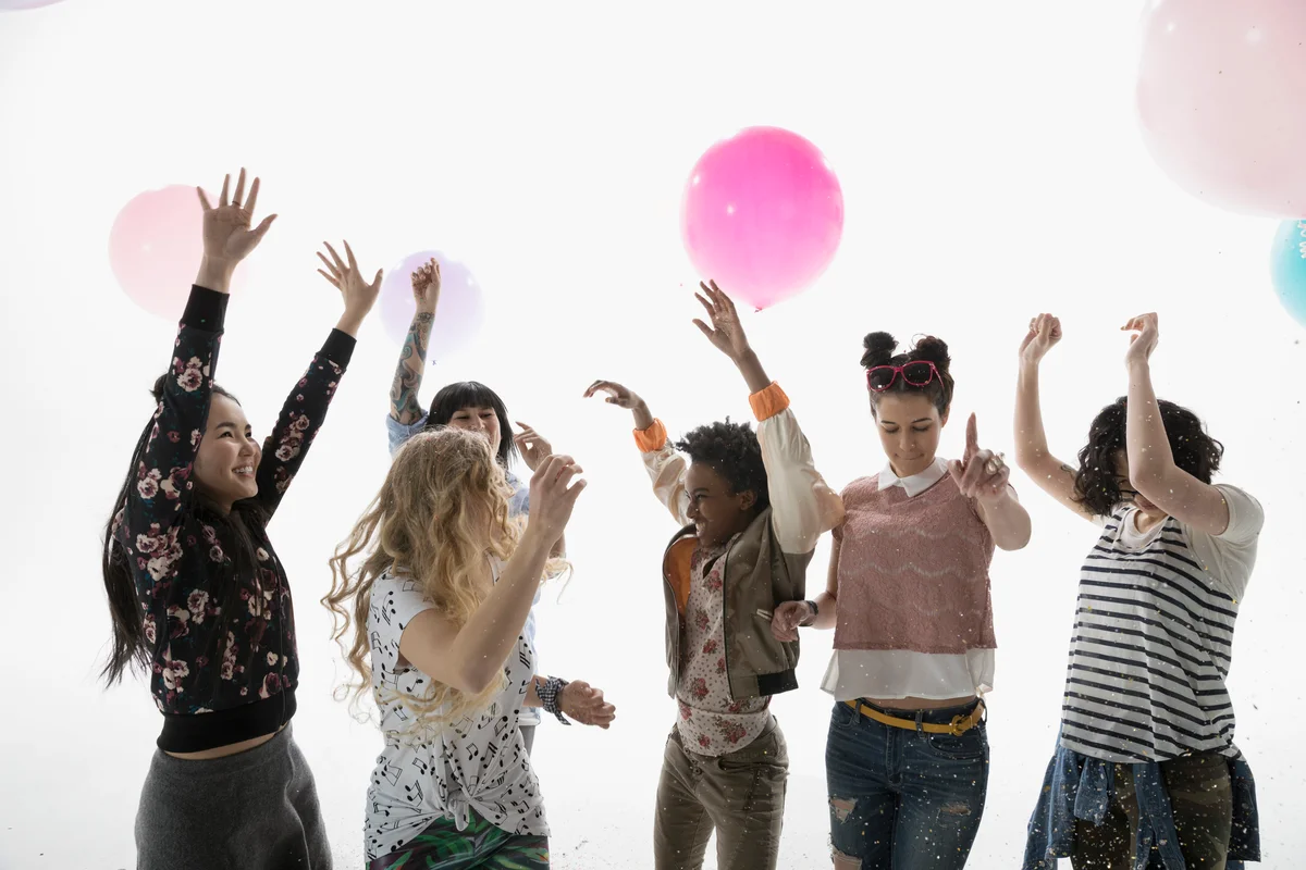 young women playing a balloon game