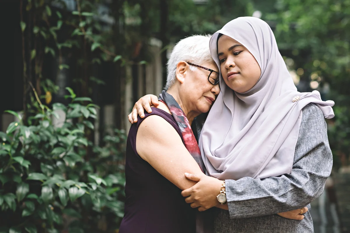 women comforting one another