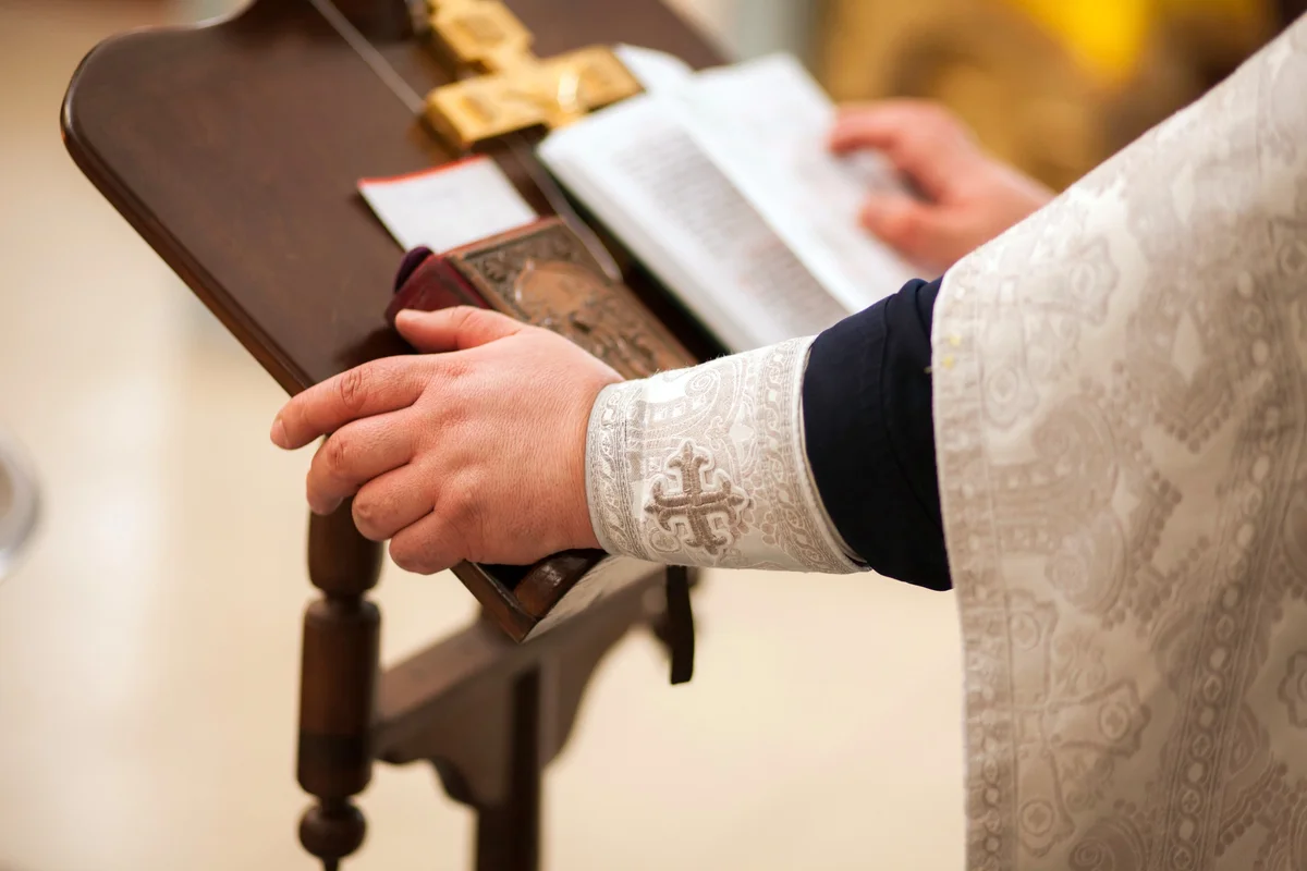 priest giving a reading