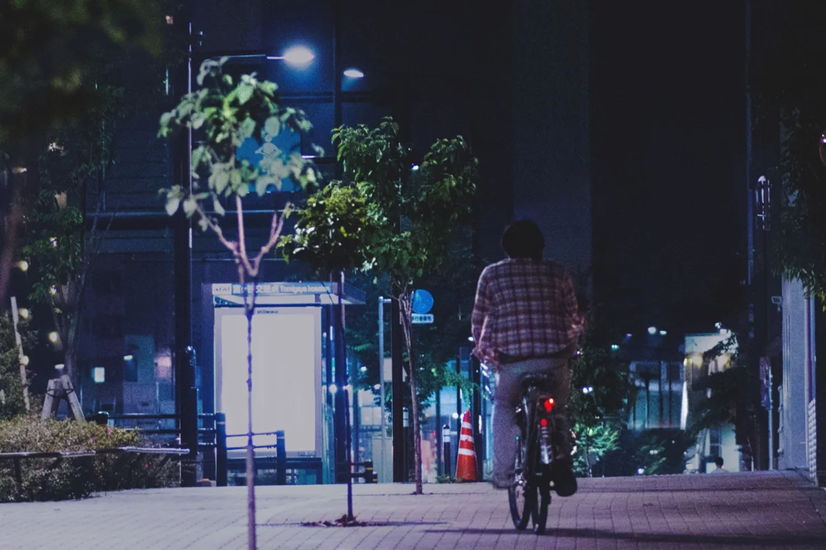 Boy on bike at night