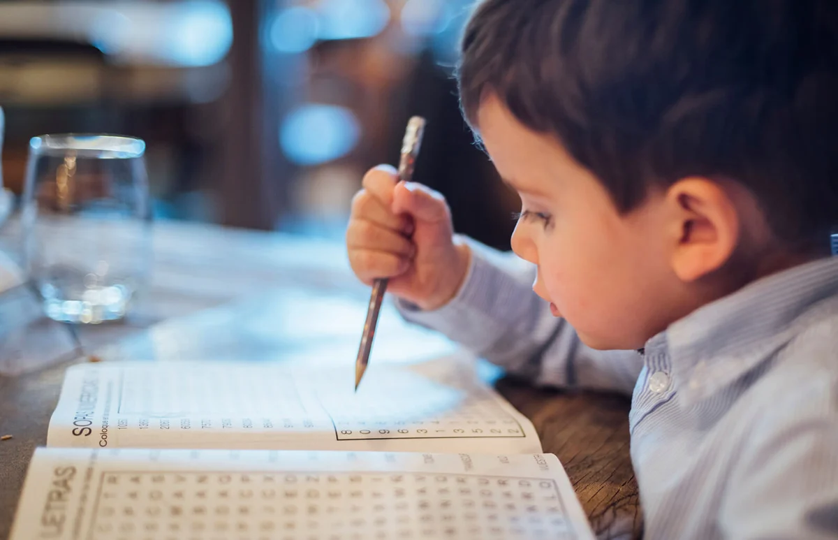 Little kid making a wordsearch