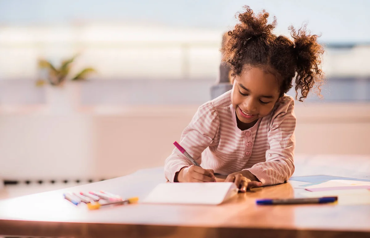 Girl at home coloring