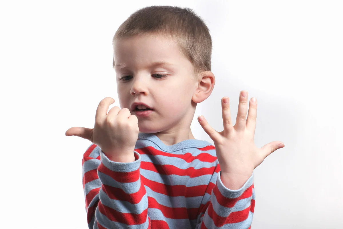 Young boy counting on his fingers