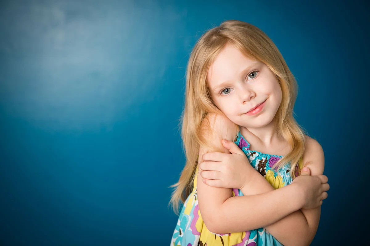 Little girl hugging herself