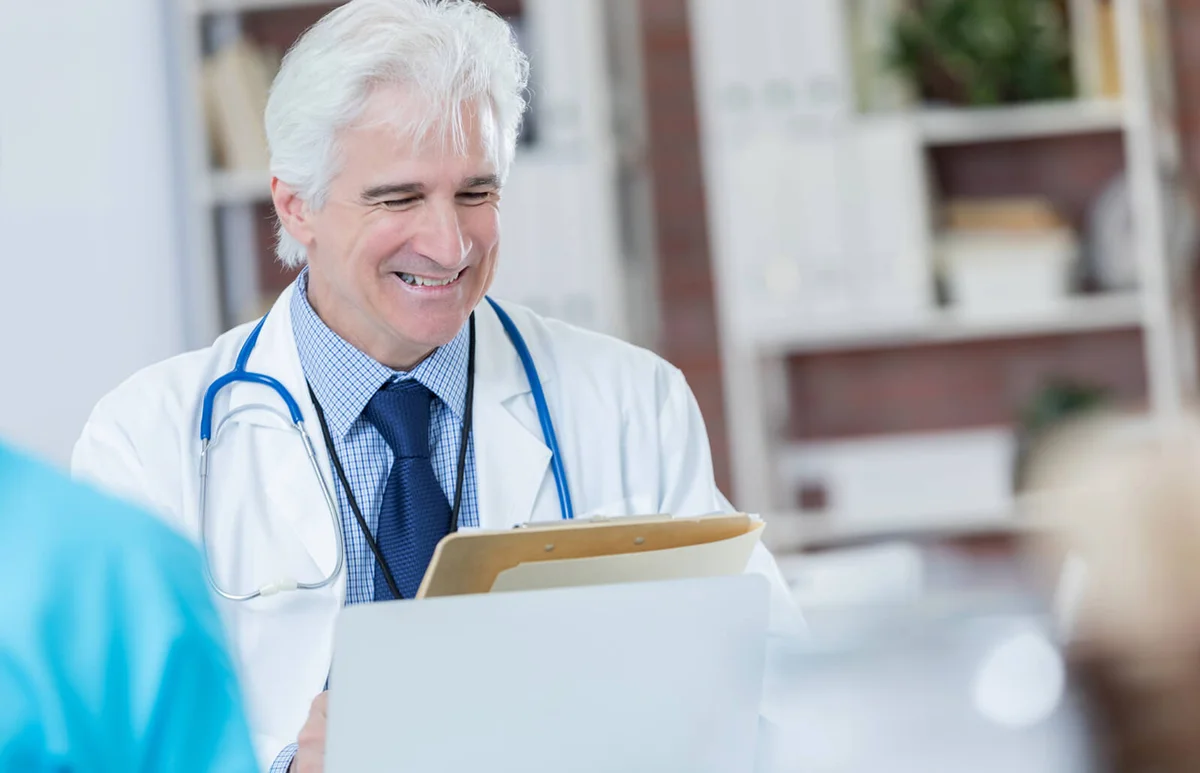 doctor talks with colleague or patient