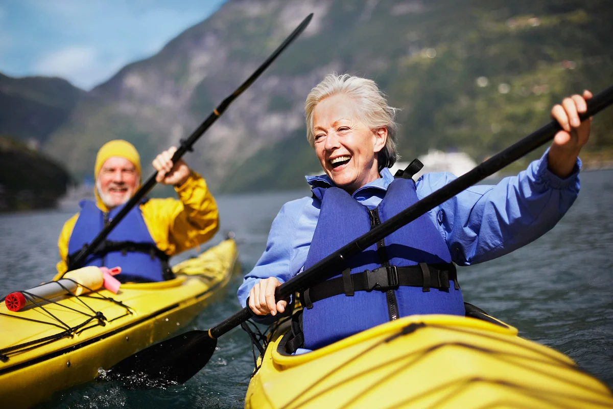 Senior couple kayaking on lake