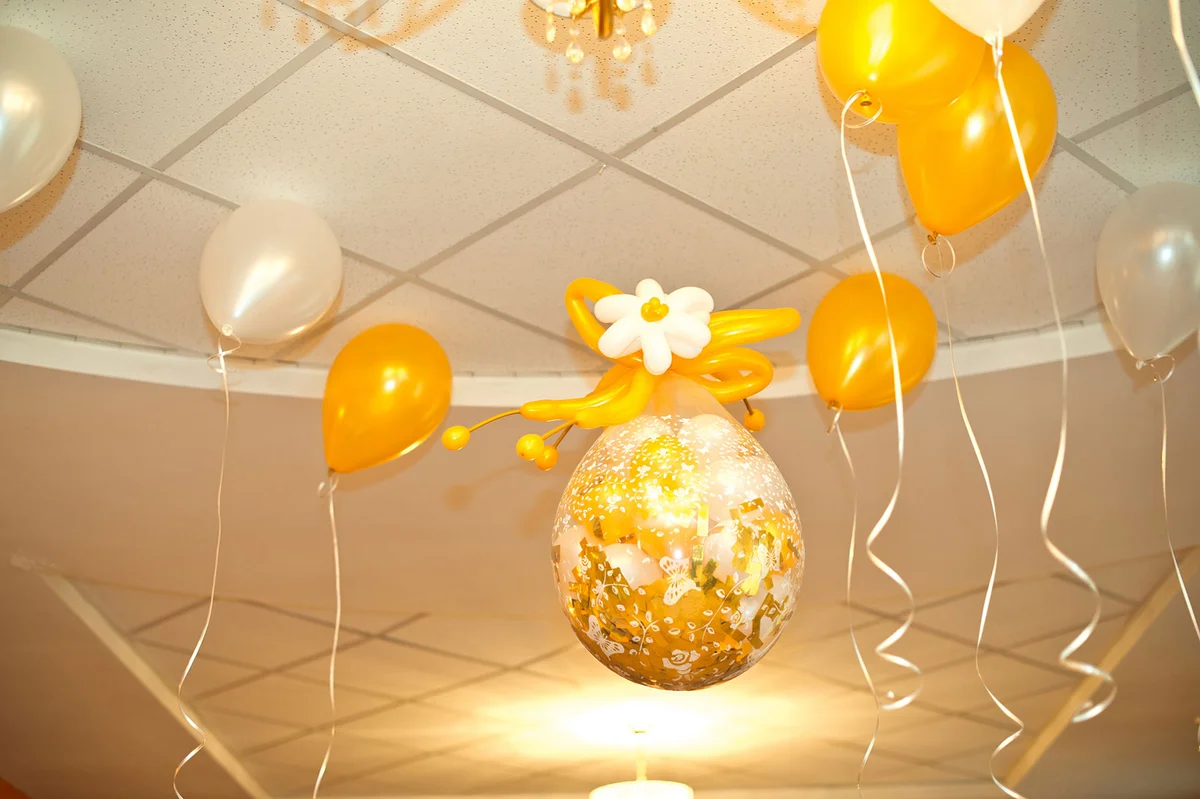 Yellow and white balloons on ceiling