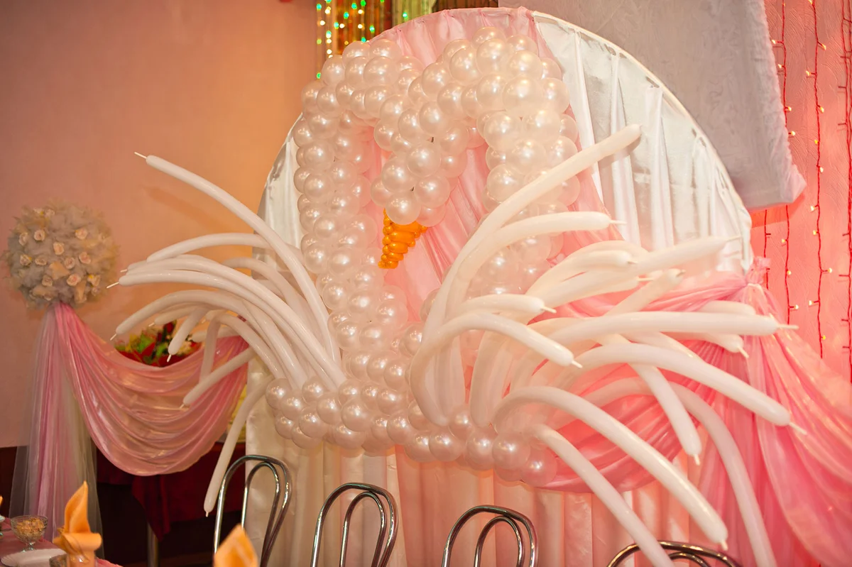 Swan balloon sculpture at wedding reception