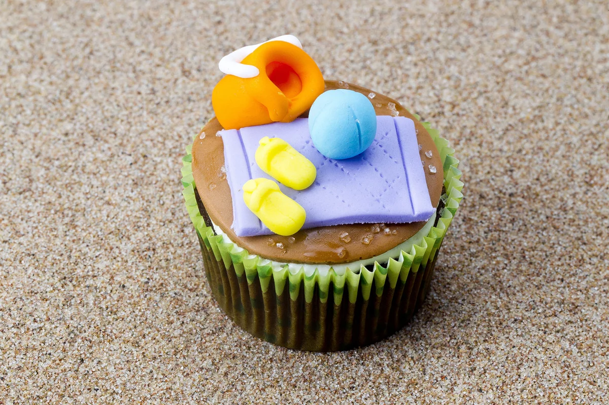 Miniature beach scene decoration on cupcakes