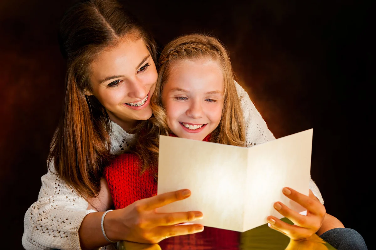 Girl reading birthday poem in card