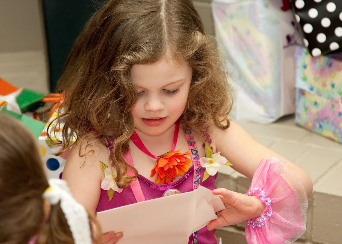 Birthday girl opening a card
