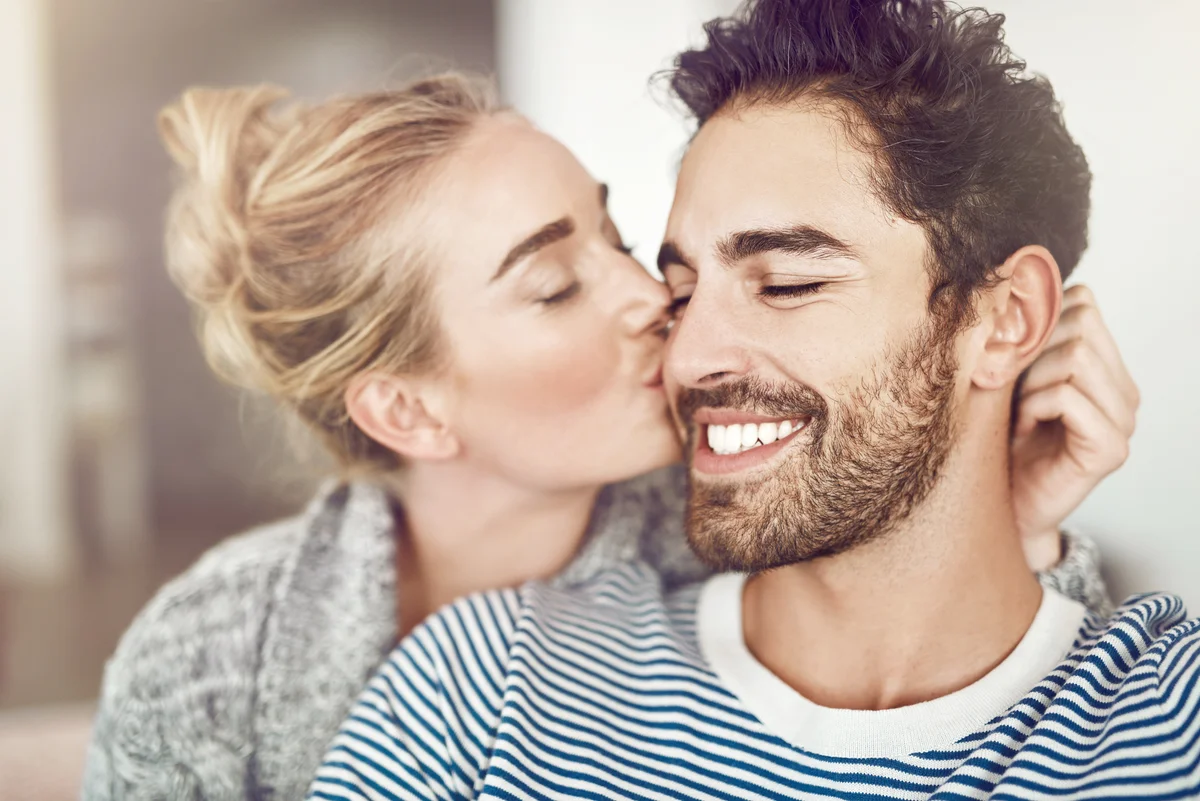 Affectionate young couple relaxing at home