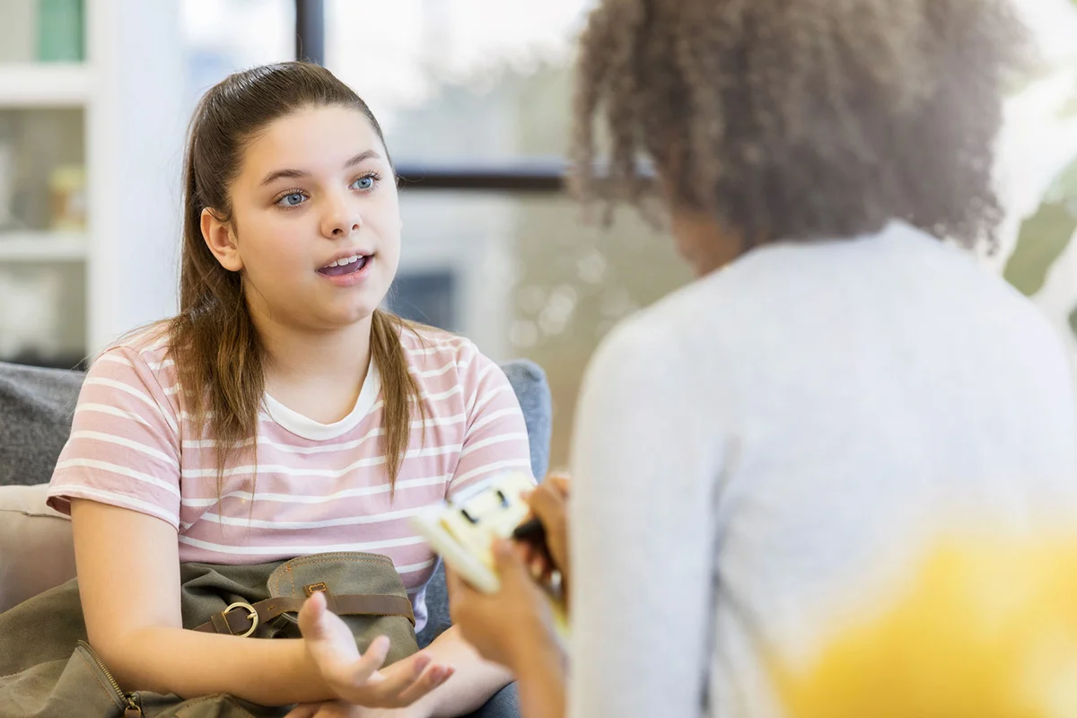 Teen girl talking with counselor