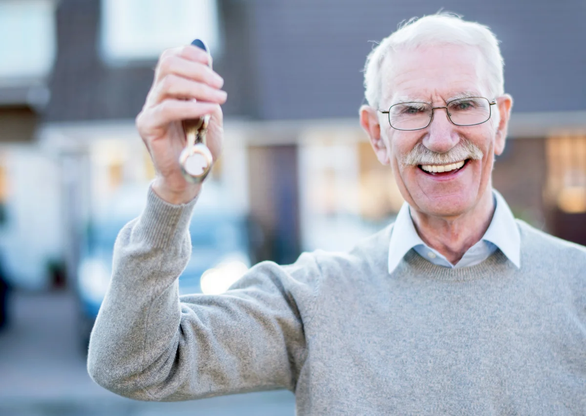 Senior man holding keys to his house