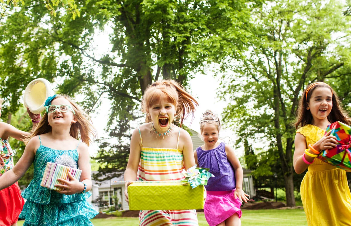 Girls carrying gifts at birthday party